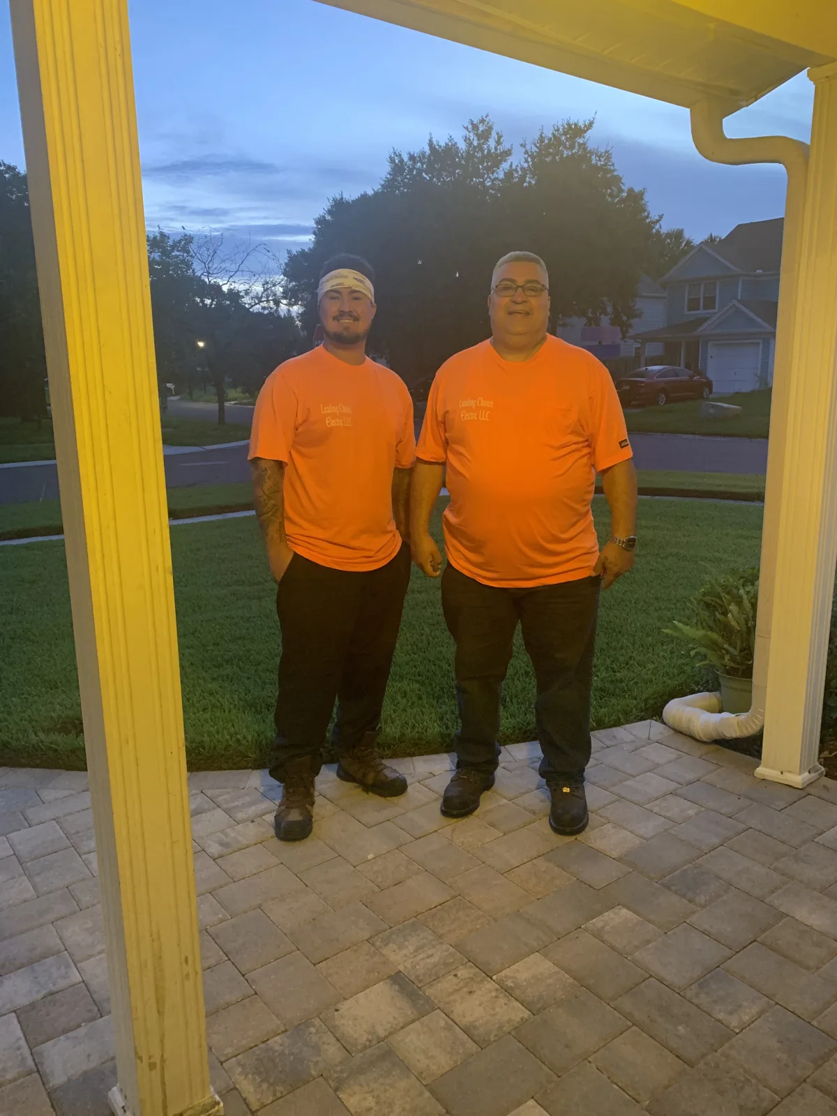 Angel and his father, the owners of Leading Choice Electric, in Leading Choice Electric shirts